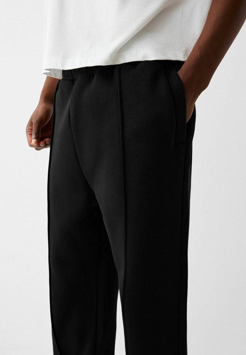 Bershka Bershka WIDE - Tracksuit bottoms - black Begrenzt auf 3 Tage