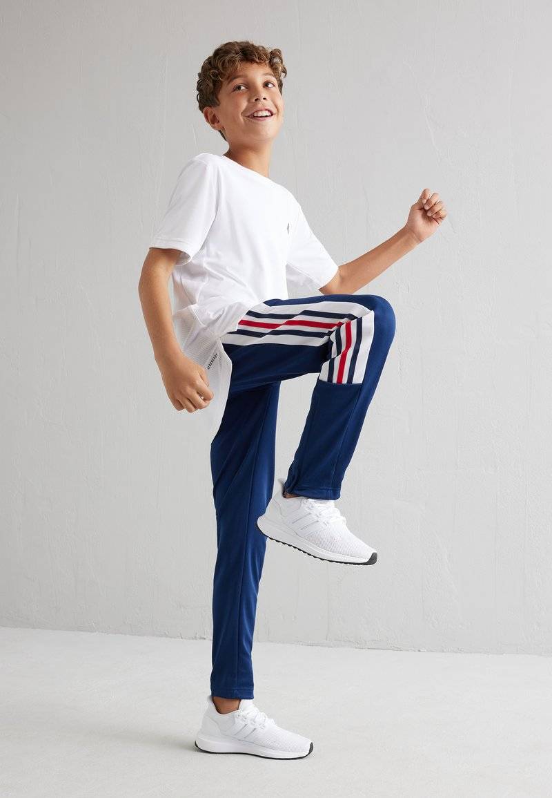 adidas Performance adidas Performance TIRO NATIONS PACK UNISEX - Tracksuit bottoms zollfrei