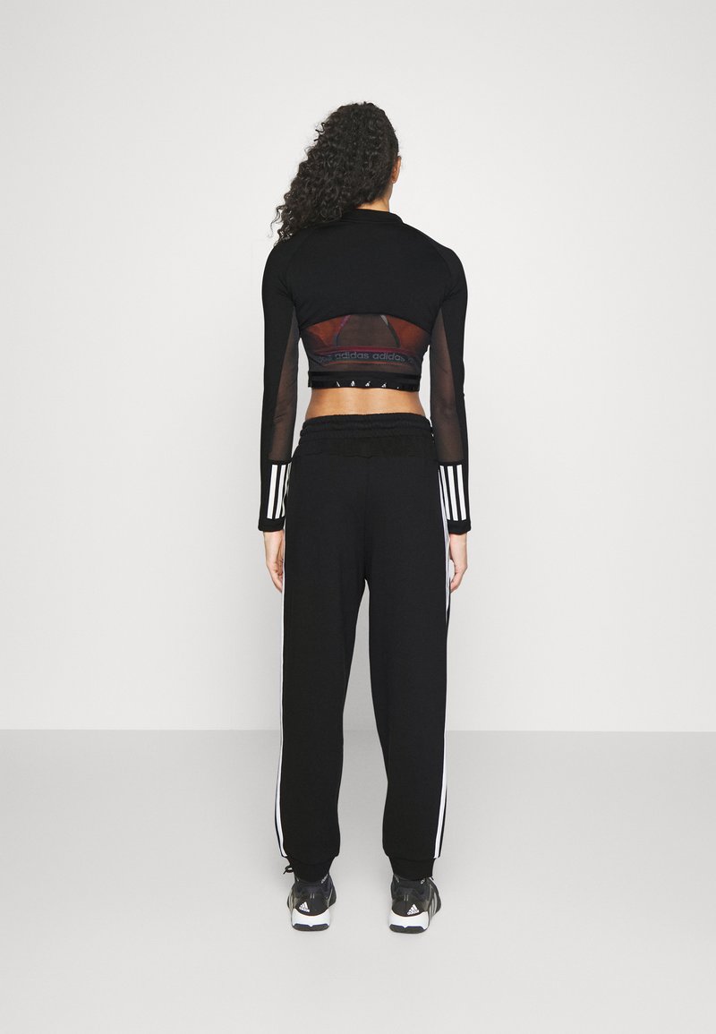 adidas Sportswear adidas Sportswear ESSENTIALS 3-STRIPES LOOSE-FIT - Tracksuit bottoms Limitierter Zeitrabatt